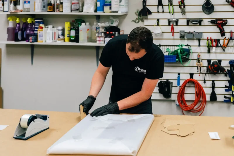 Man wrapping up a restored painting