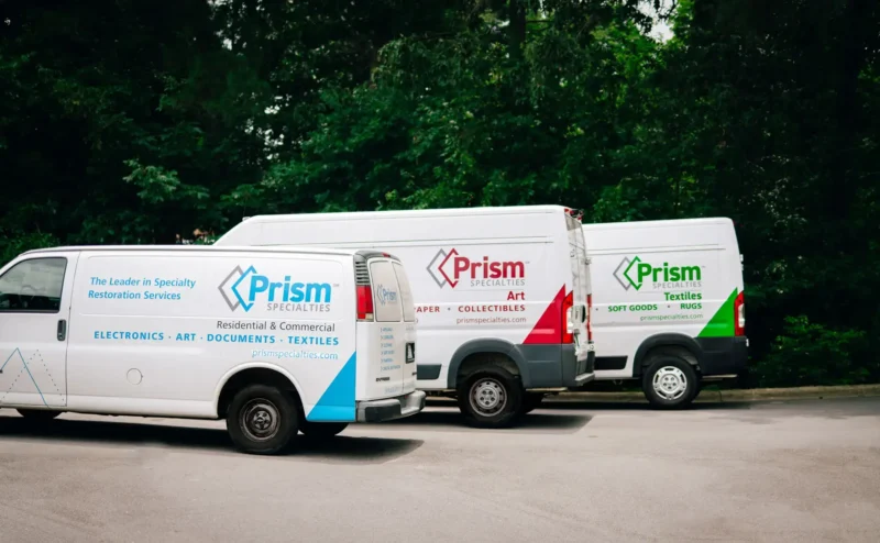 Lineup of Prism Specialties vehicles parked next to each other