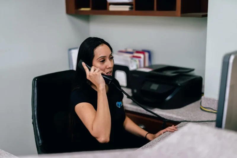 Prism Specialties team member talking on the phone.